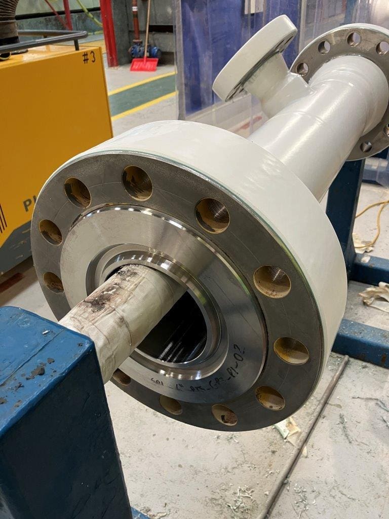 Pipe spool with flanged end coated in white 2LPP (2 Layer Polypropylene) at LJF Custom Coatings facility